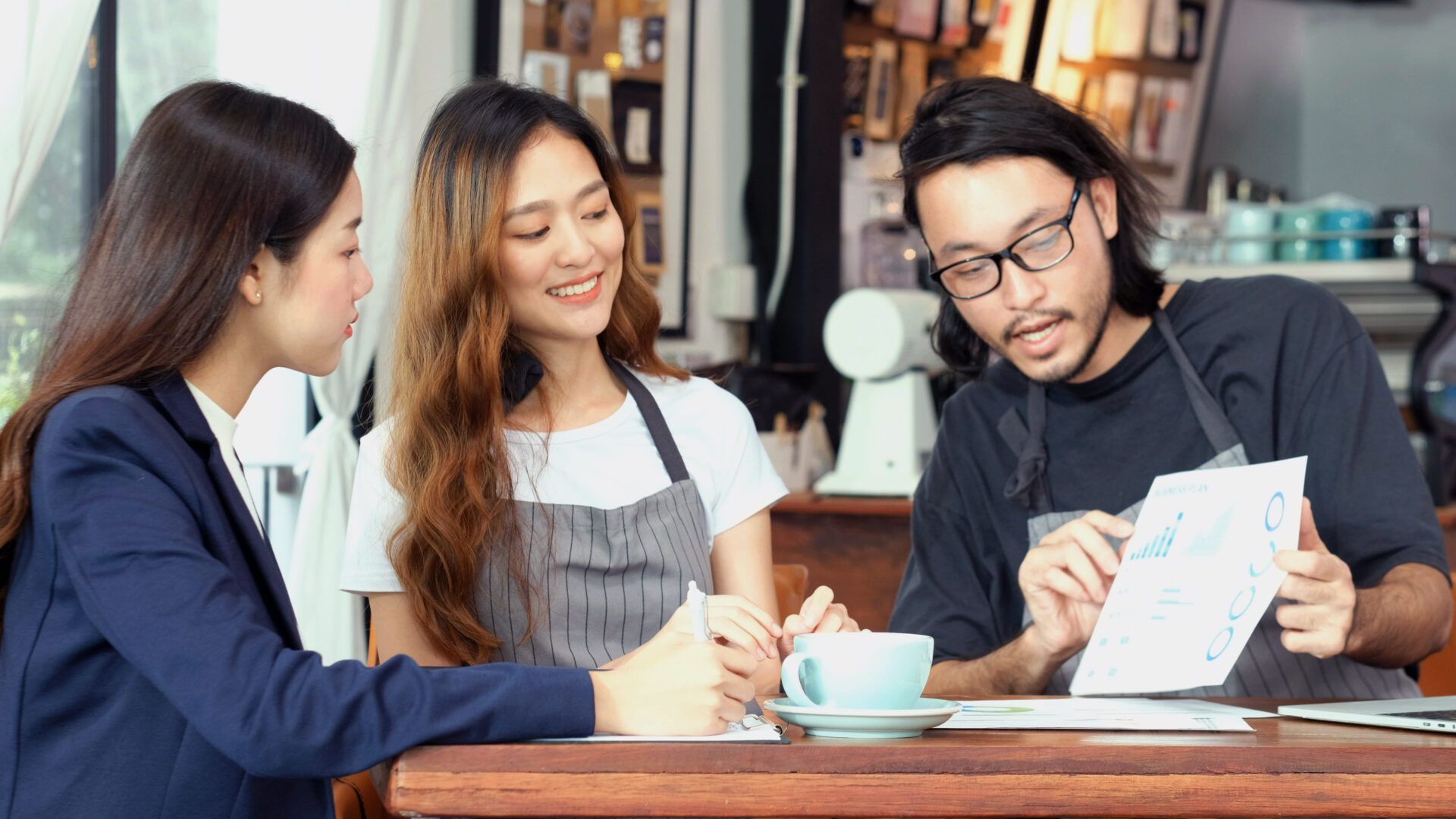 Young asian business woman discussing about financial planning with small business owner at cafe coffee shop, Business meeting corporate partnership, Asia financal loan for start up new business